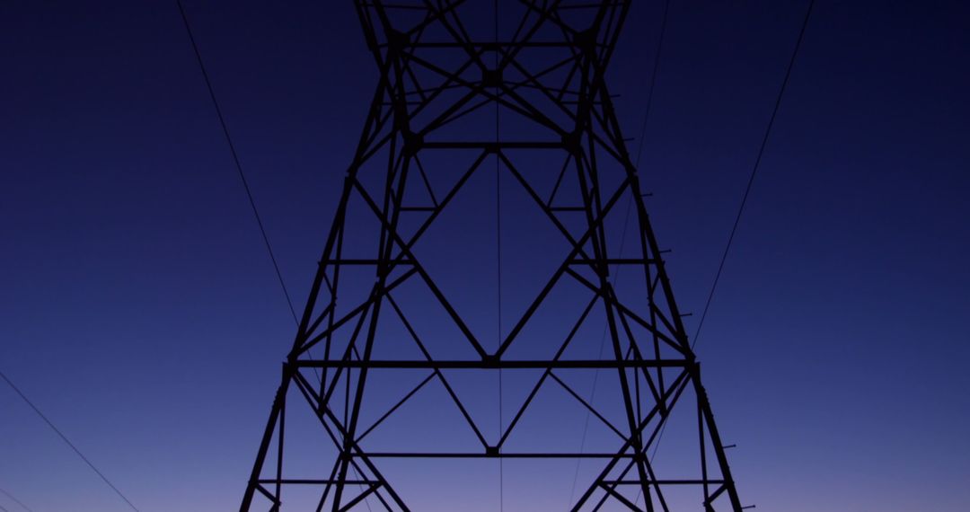 Dusk Silhouette of Electricity Tower Capturing Energy Transition