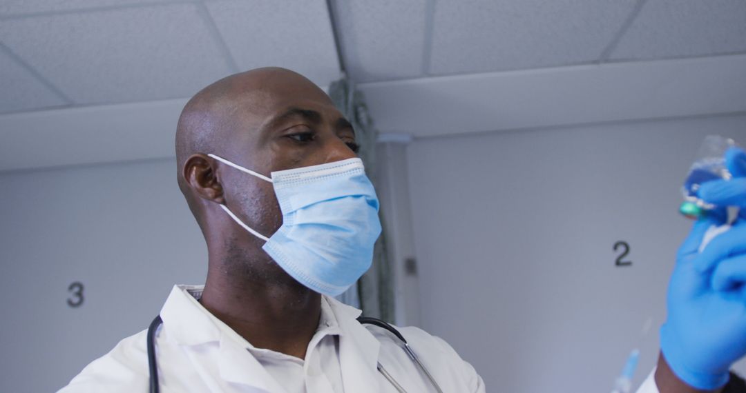 Healthcare Professional Wearing Mask and Gloves in Medical Setting - Free Images, Stock Photos and Pictures on Pikwizard.com