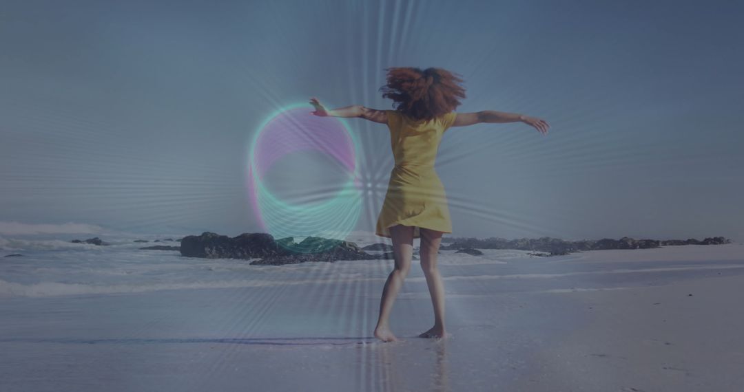 Joyful woman dancing on sunny beach in yellow dress