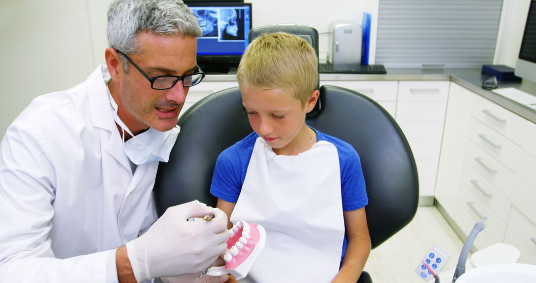 Dentist Explaining Dental Procedure to Child in Clinic - Free Images, Stock Photos and Pictures on Pikwizard.com