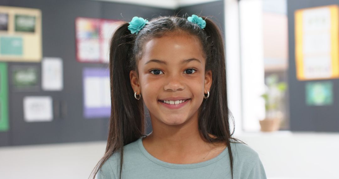 Smiling Girl with Pigtails Brightens Classroom Setting