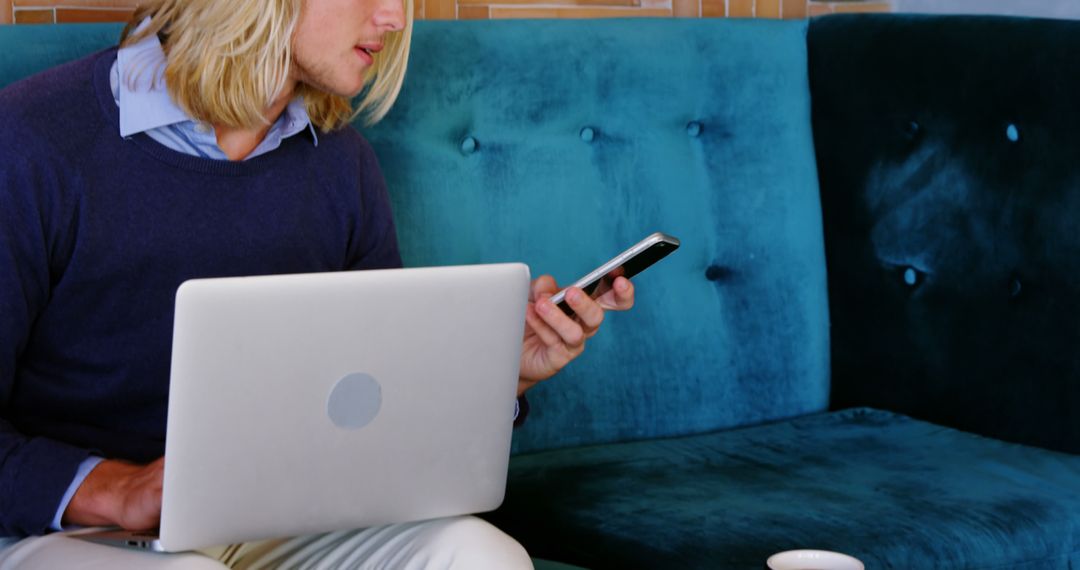 Businessman Using Smartphone and Laptop on Couch - Free Images, Stock Photos and Pictures on Pikwizard.com