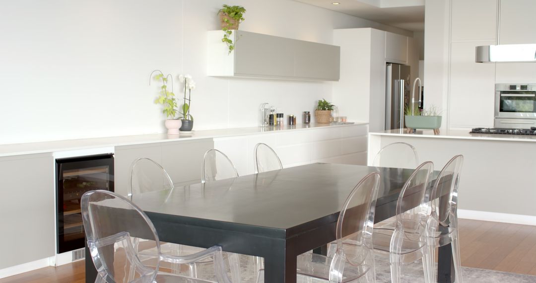 Modern kitchen with black dining table and clear acrylic chairs