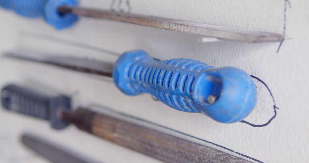 Close-Up of Blue Handled Tools on Workshop Wall - Free Images, Stock Photos and Pictures on Pikwizard.com