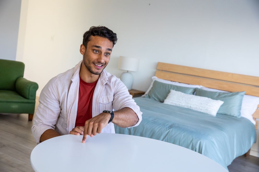Man in Relaxed Bedroom Pointing Enthusiastically