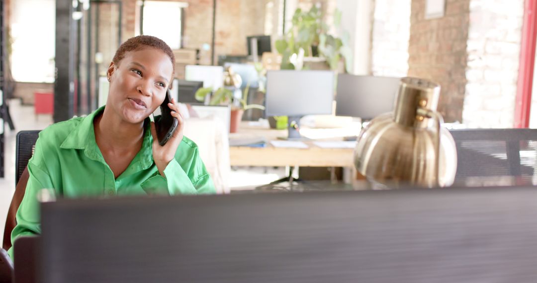 Professional Woman Talking on Phone in Modern Office Workspace - Free Images, Stock Photos and Pictures on Pikwizard.com