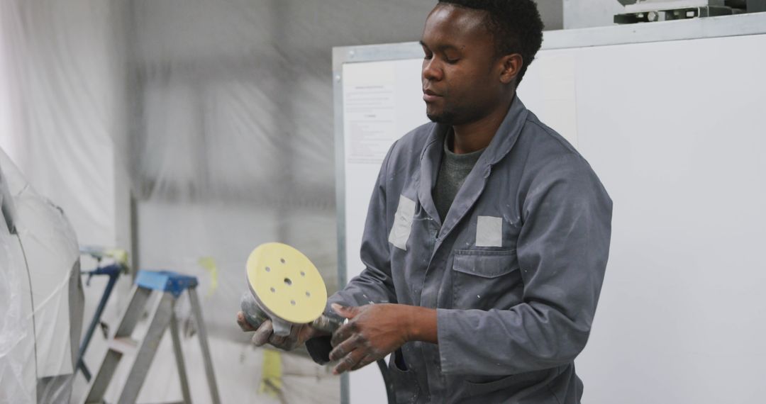 Mechanic Exploring Polishing Tool in Workshop