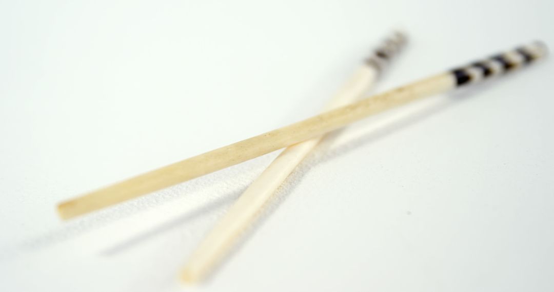 Close-up of Wooden Chopsticks on White Background - Free Images, Stock Photos and Pictures on Pikwizard.com