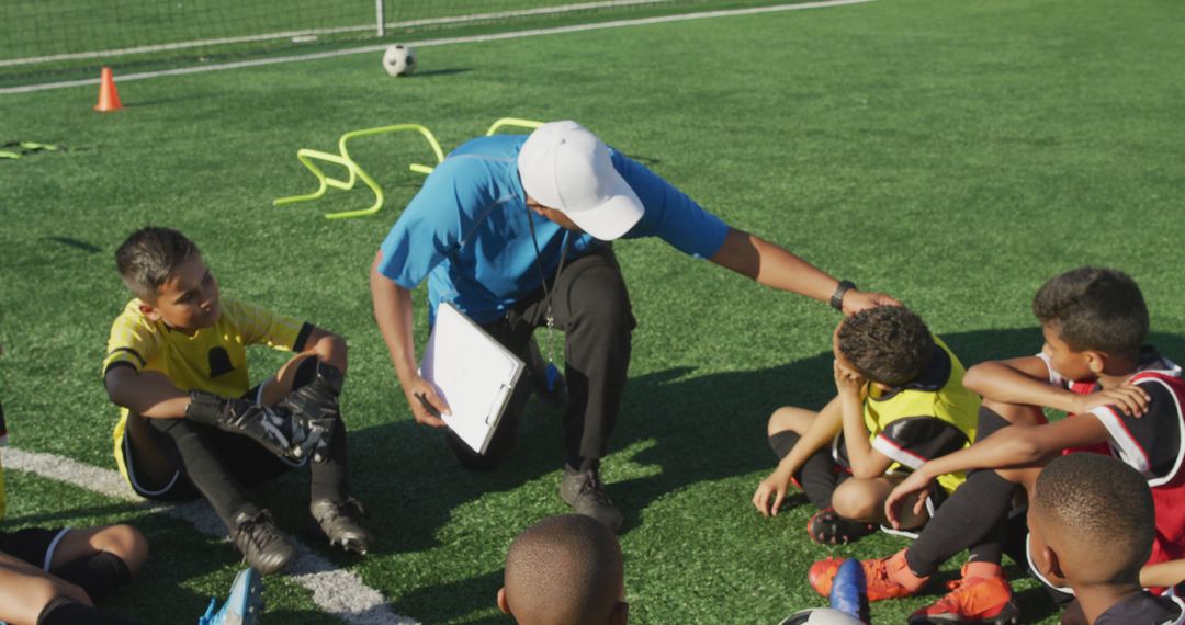 Coach Motivating Young Soccer Players During Break on Field - Free Images, Stock Photos and Pictures on Pikwizard.com