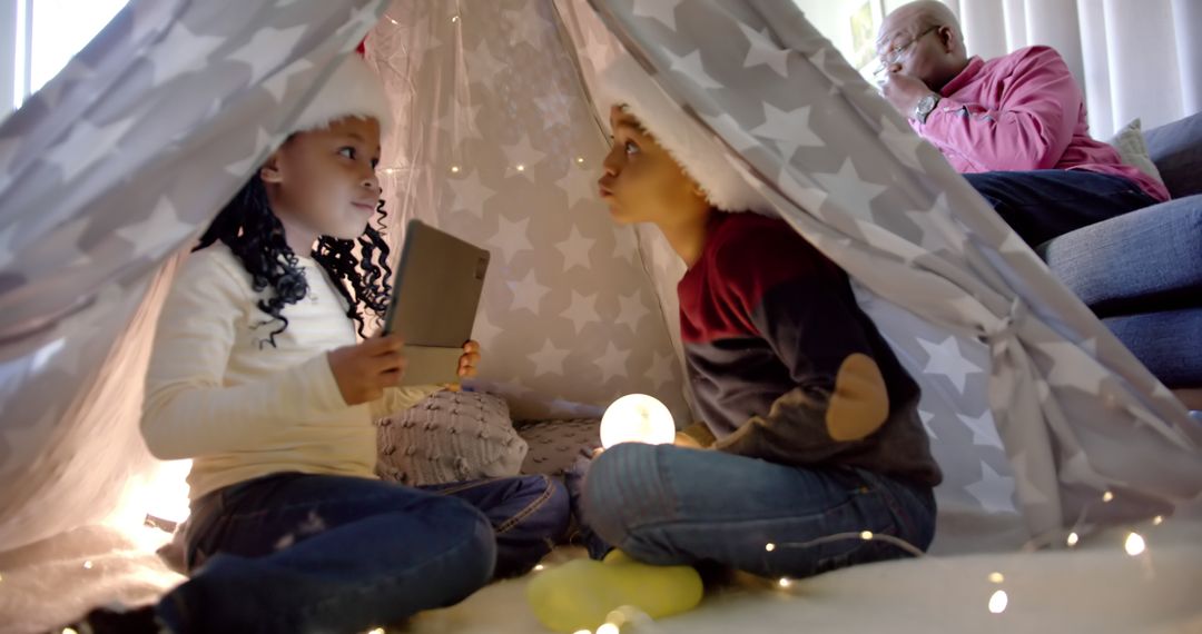 Children Enjoying Indoor Tent on Christmas - Free Images, Stock Photos and Pictures on Pikwizard.com