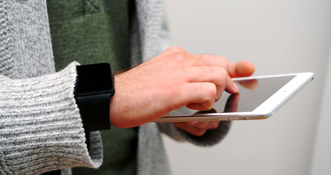 Person Using Tablet with Smartwatch on Wrist - Free Images, Stock Photos and Pictures on Pikwizard.com