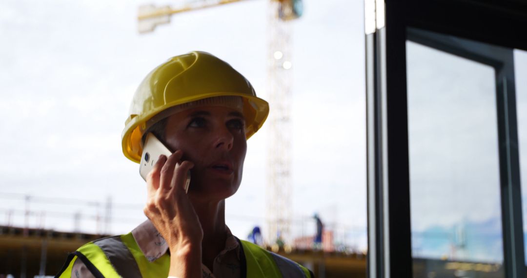 Confident Female Architect Communicating on Construction Site - Free Images, Stock Photos and Pictures on Pikwizard.com