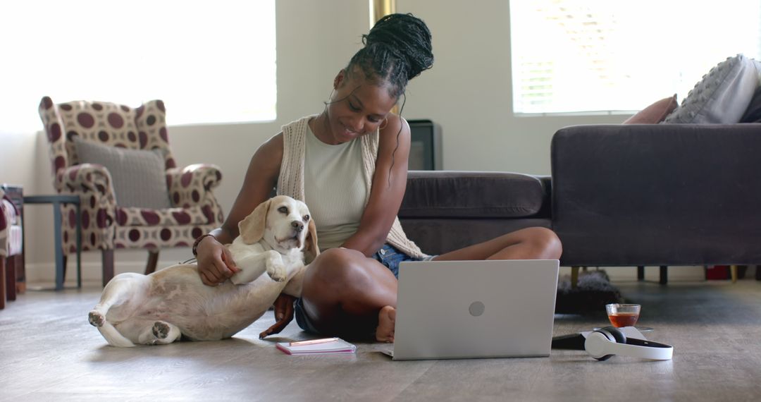 Woman Relaxing with Dog While Using Laptop at Home