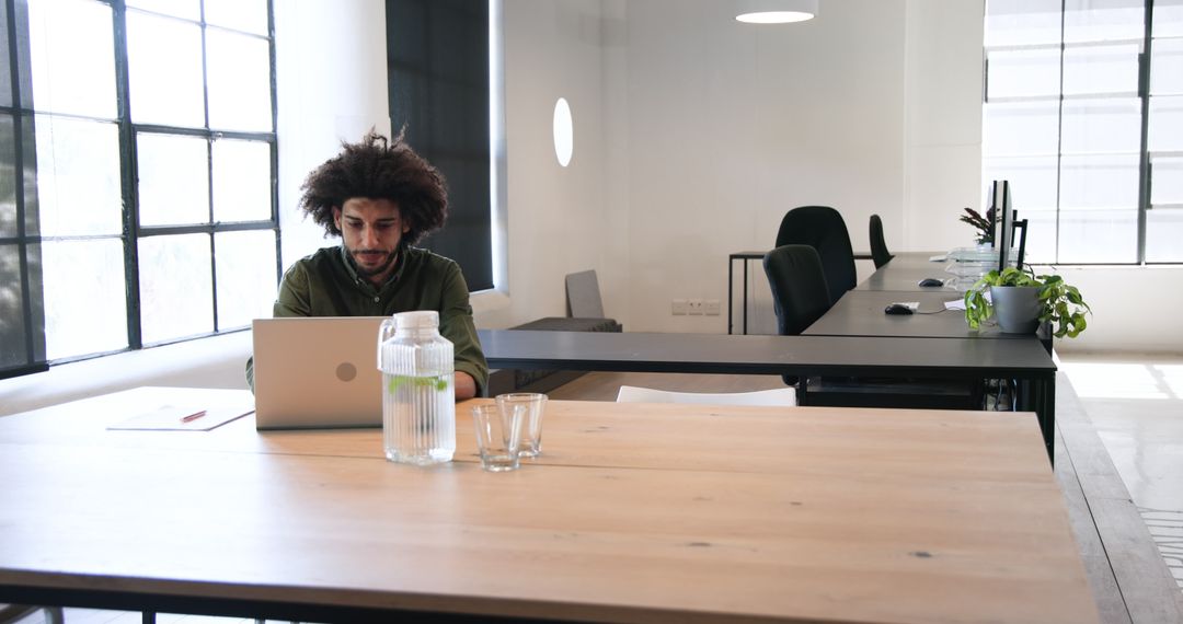Man Working on Laptop in Modern Minimalist Office Space