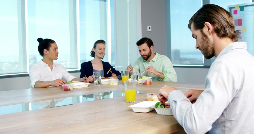 Business Executives Enjoying Lunch in Office Meeting Room
