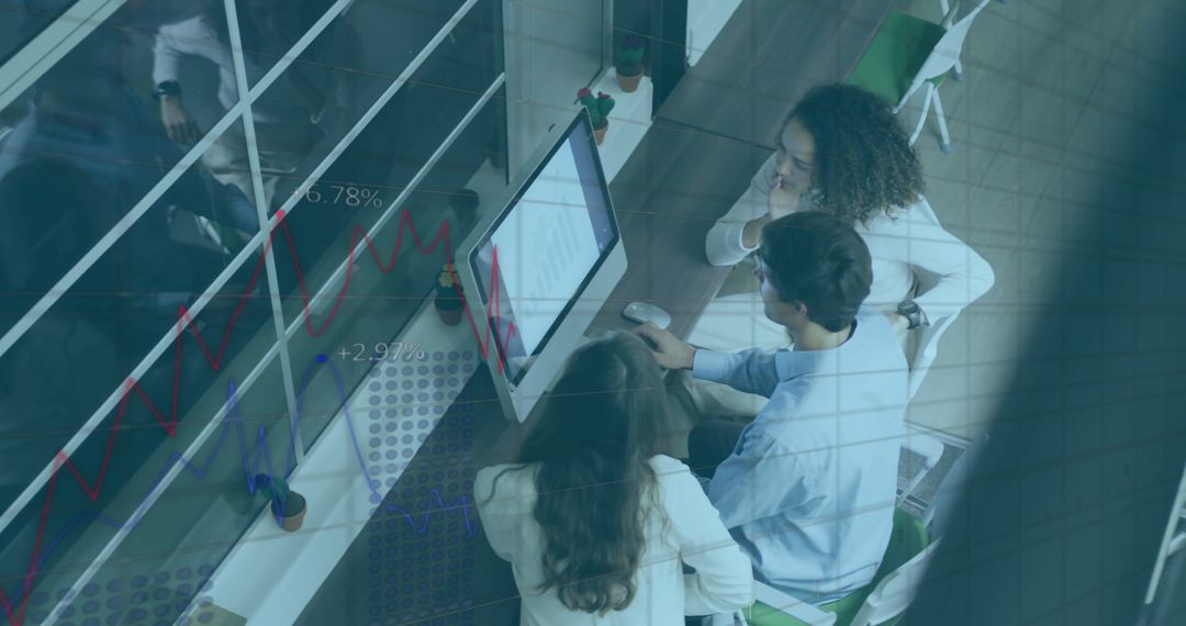 Diverse Team Analyzing Financial Data on Computer Screen in Office