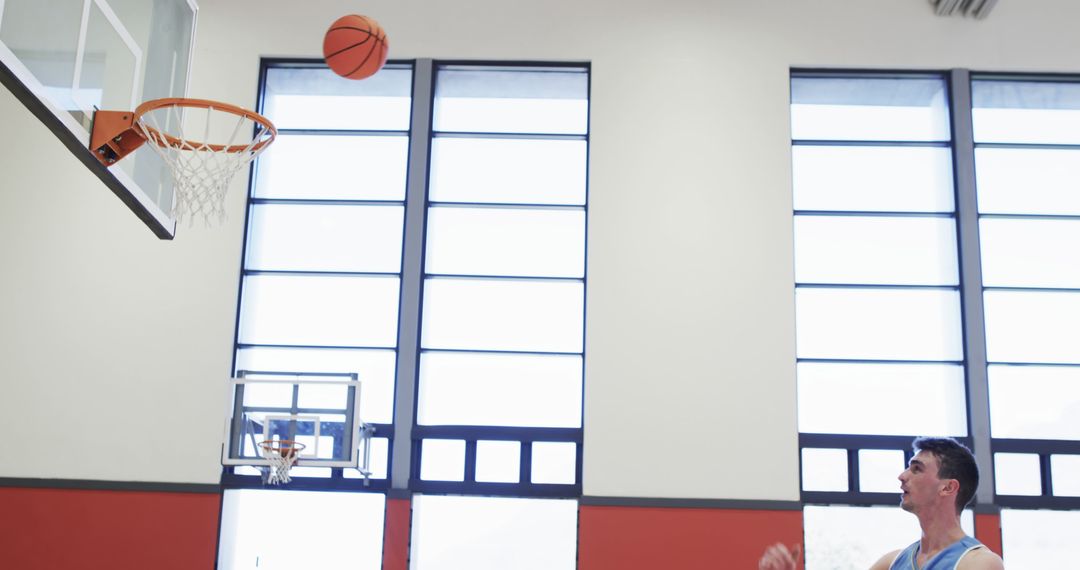 Basketball Player Shooting Ball at Indoor Court - Free Images, Stock Photos and Pictures on Pikwizard.com