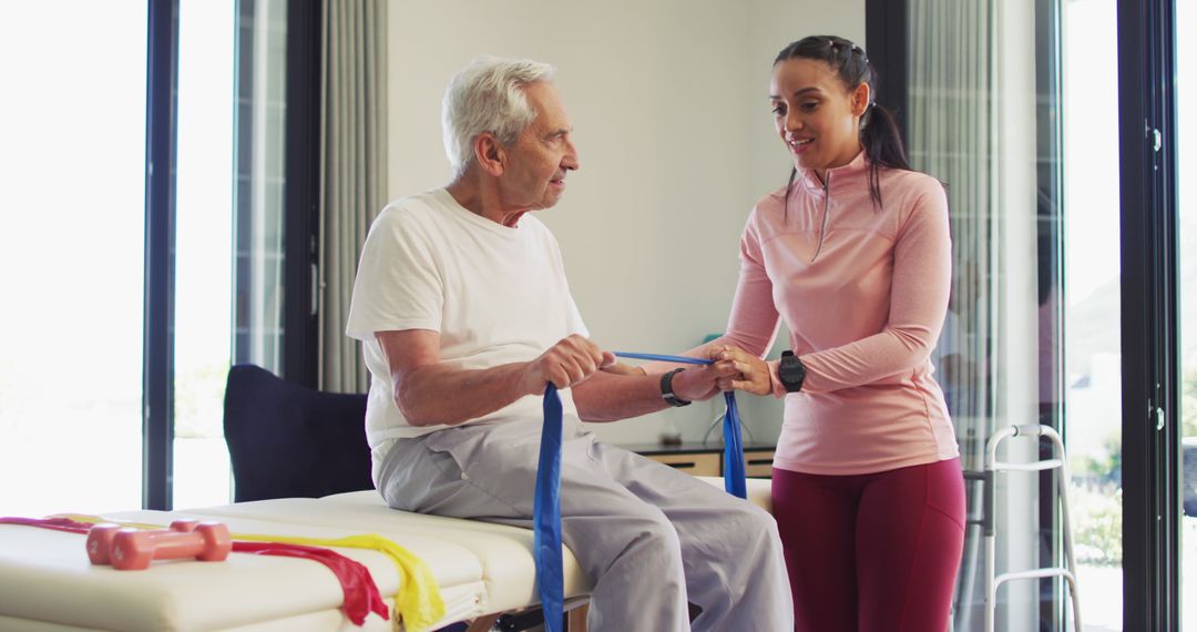 Senior man engaging in physical therapy with young therapist - Free Images, Stock Photos and Pictures on Pikwizard.com