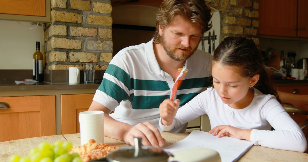 Middle-aged Man Helping Girl with Homework in Cozy Kitchen Setting, Copy Space - Free Images, Stock Photos and Pictures on Pikwizard.com