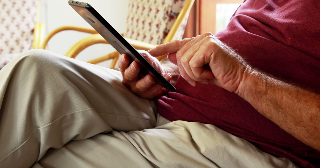 Senior Using Tablet While Relaxing in a Rocking Chair - Free Images, Stock Photos and Pictures on Pikwizard.com