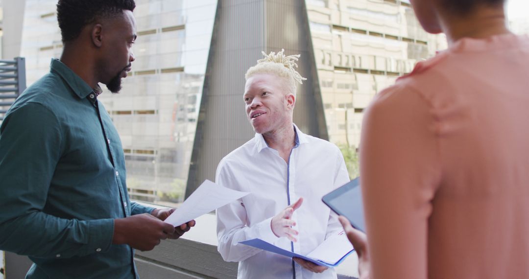 Diverse Colleagues in Lively Discussion in Modern Office