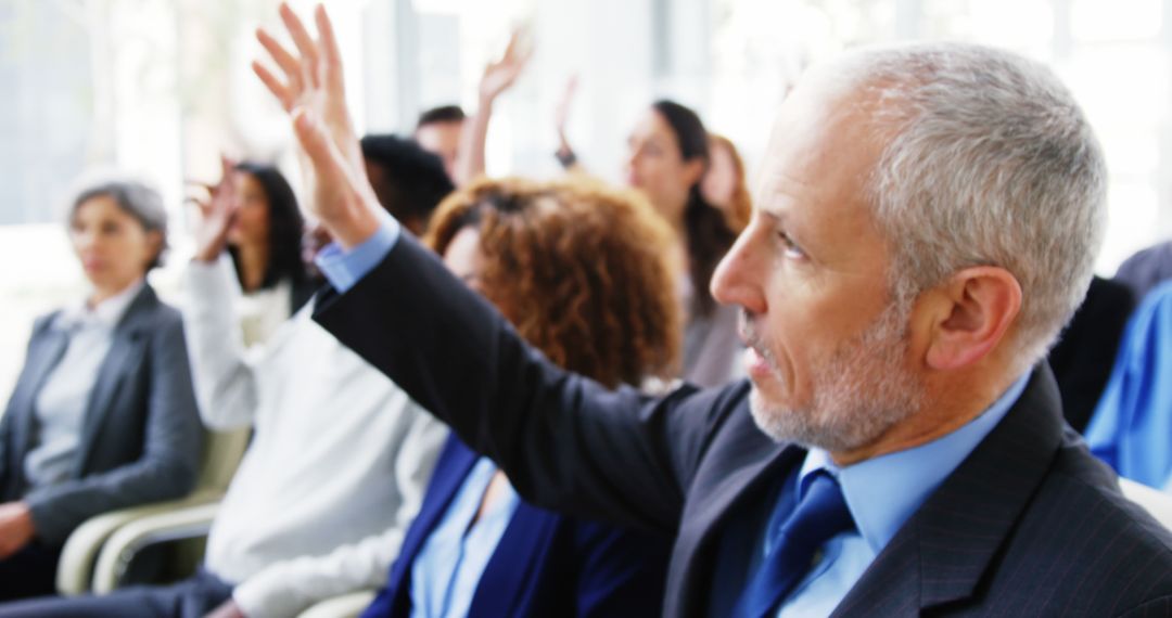 Senior Businessman Raising Hand During Business Meeting - Free Images, Stock Photos and Pictures on Pikwizard.com