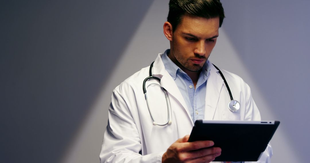 Doctor Utilizing Digital Tablet in Modern Hospital Environment