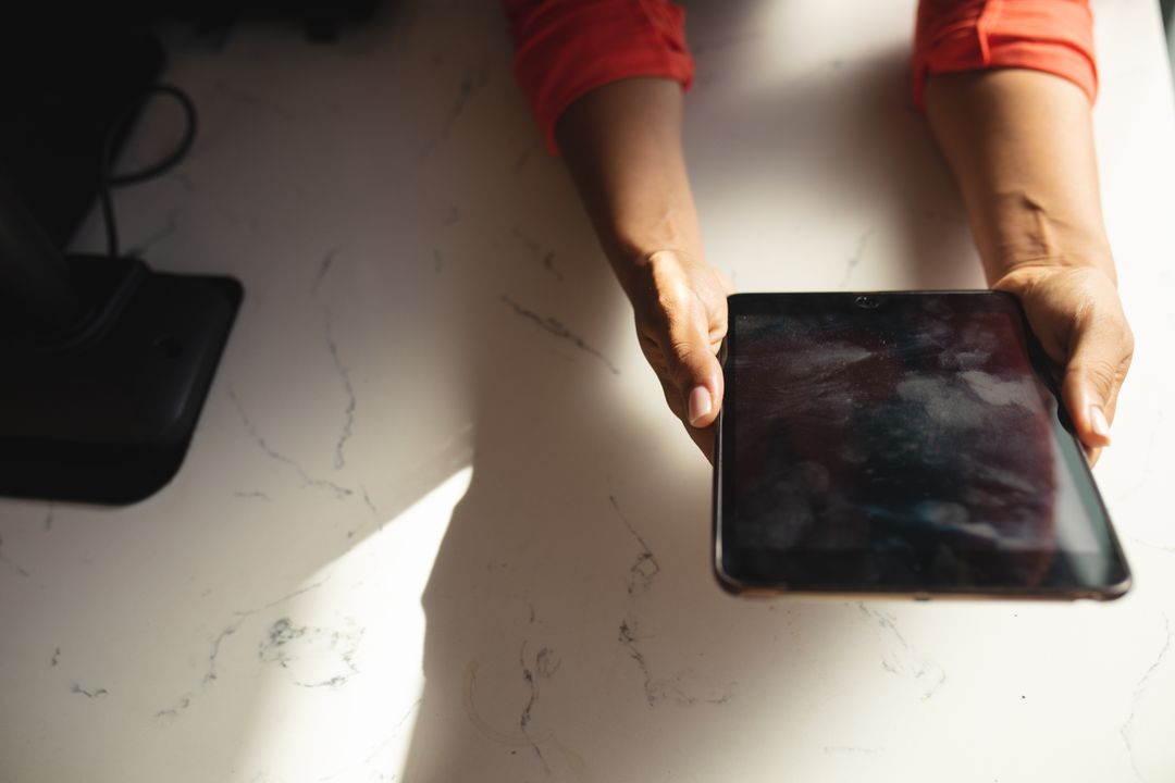 Hands Holding Digital Tablet on Marble Table in Cafe - Free Images, Stock Photos and Pictures on Pikwizard.com