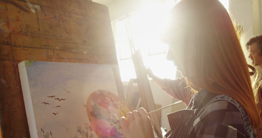 Female Artist Creating a Painting in Sunlit Studio - Free Images, Stock Photos and Pictures on Pikwizard.com