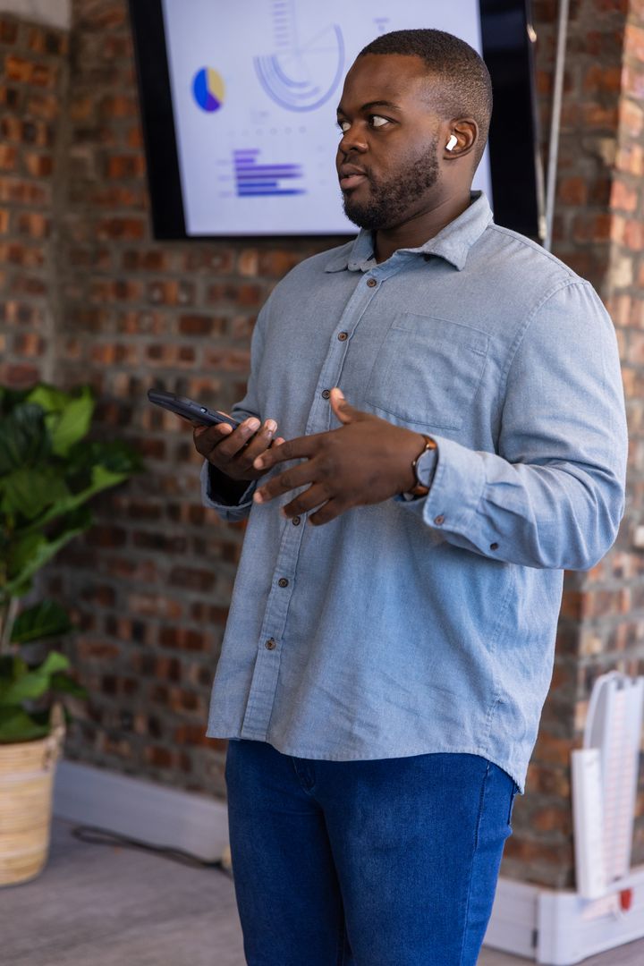 Business Professional Presenting Data Using Smartphone and Technology