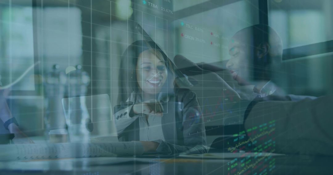 Leader pointing at laptop while team reviews interactive analytics and financial charts