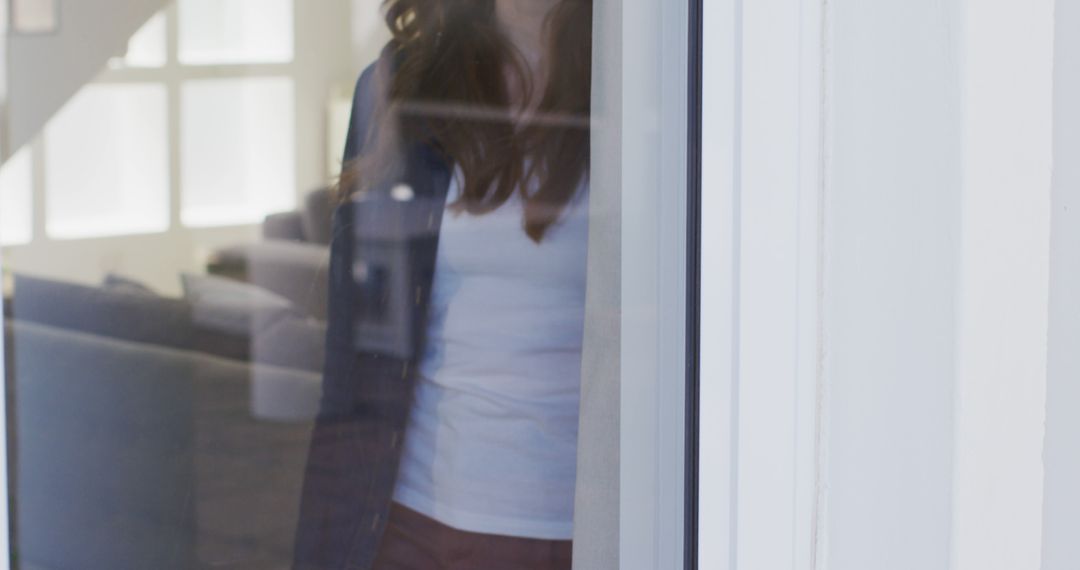 Midsection of caucasian woman standing by window at home - Free Images, Stock Photos and Pictures on Pikwizard.com