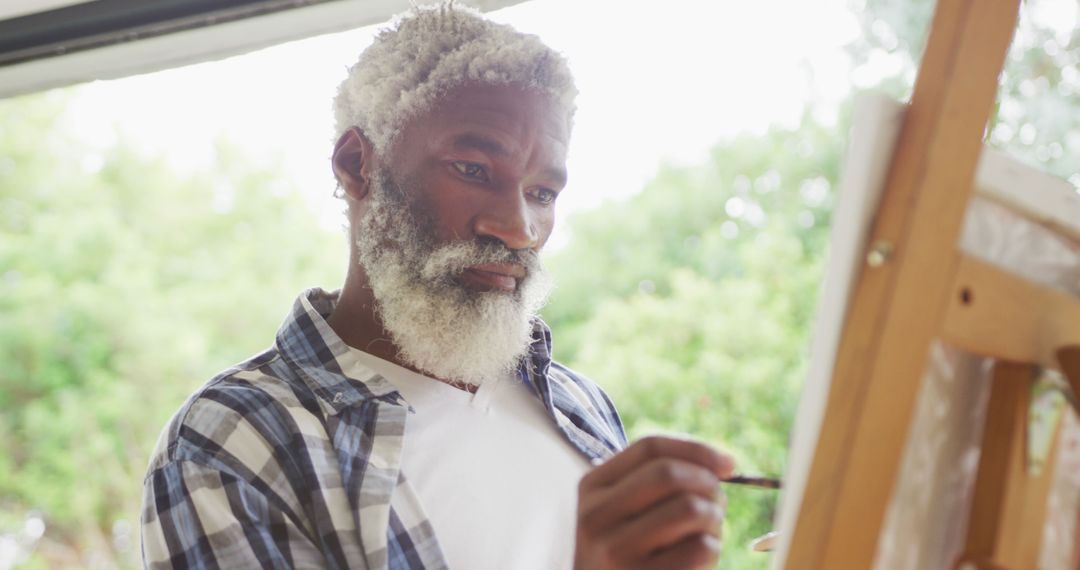 Image of african american senior man painting picture outside - Free Images, Stock Photos and Pictures on Pikwizard.com