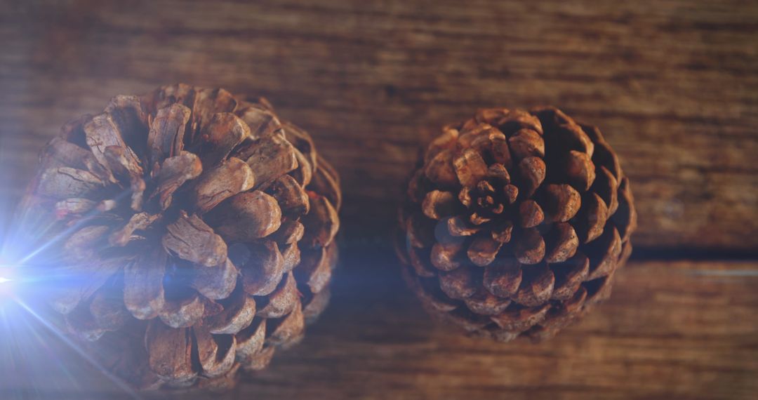 Illuminated Pinecones on Rustic Wooden Background