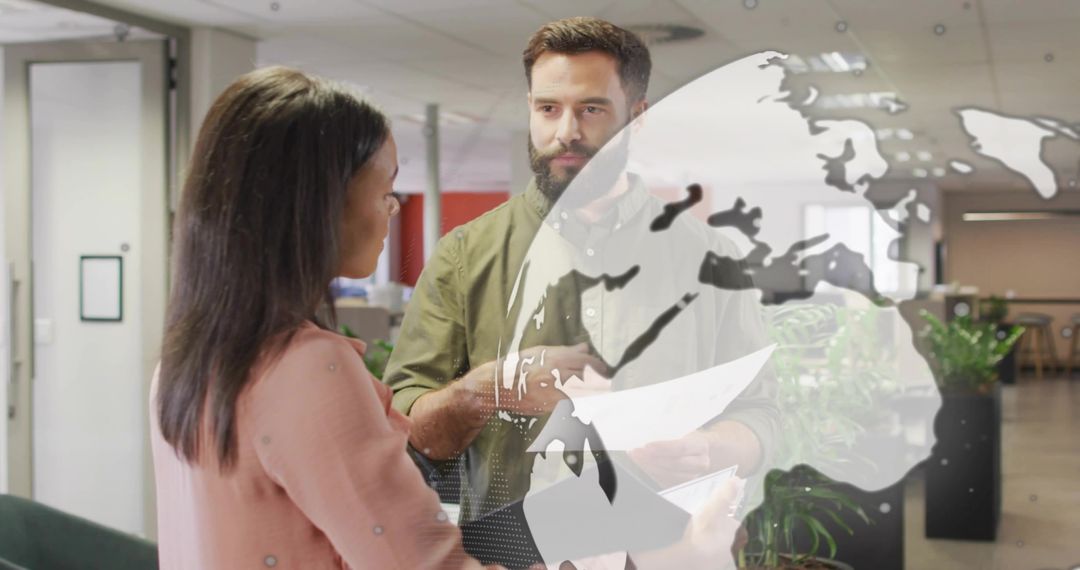 Team discussing documents in modern office with globe overlay for global collaboration