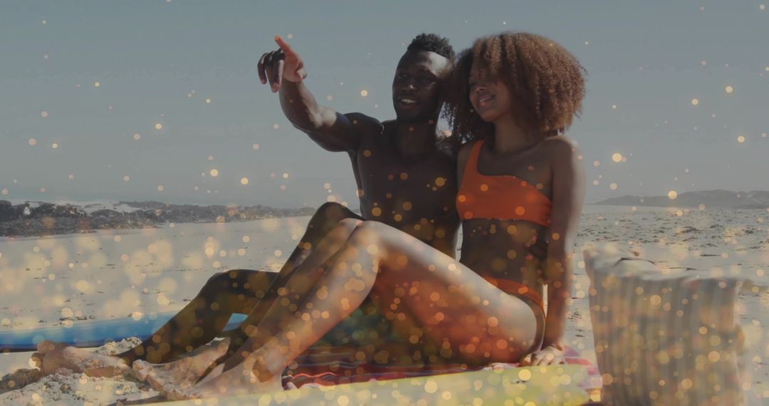 Couple Relaxing on Beach Pointing Towards Horizon