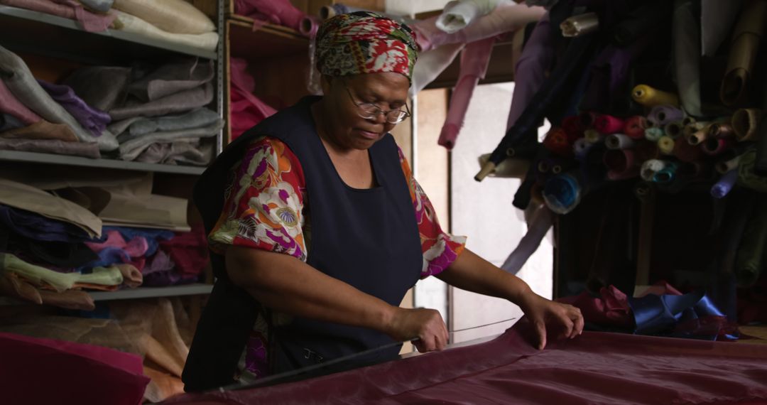 Afro-Latina Woman Working in Fabric Store Cutting Textile - Free Images, Stock Photos and Pictures on Pikwizard.com