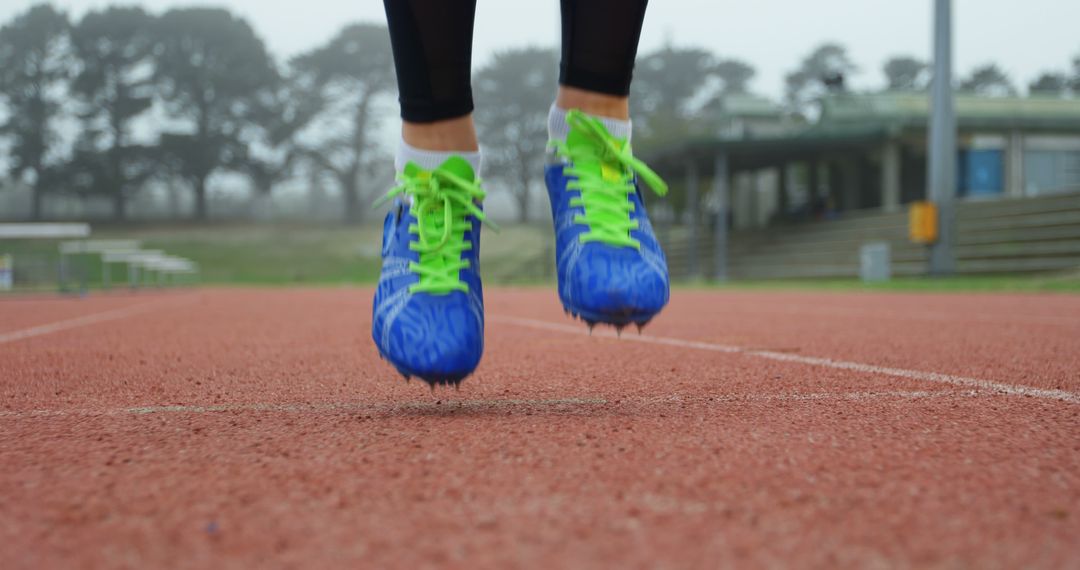 Close-up of Runner's Feet in Action with Bright Blue Shoes on Track - Free Images, Stock Photos and Pictures on Pikwizard.com