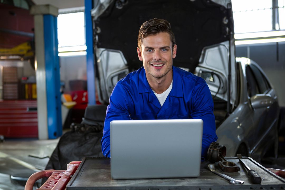 Mechanic Using Laptop in Garage Workshop Technician Maintenance