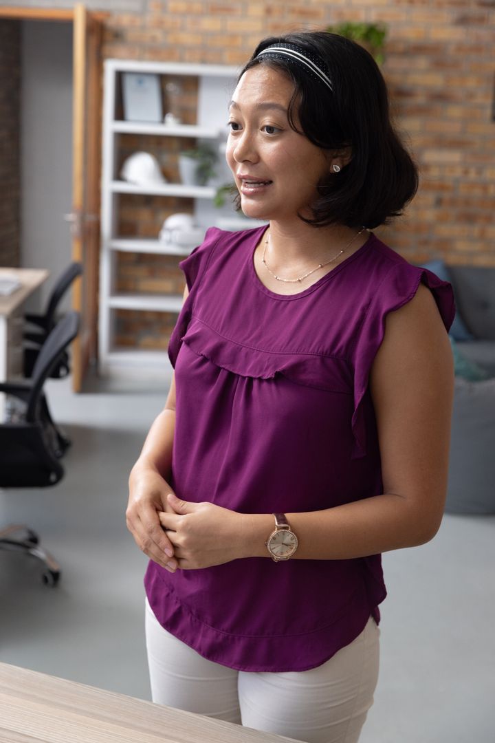 Confident Professional Presenting Ideas in Modern Office