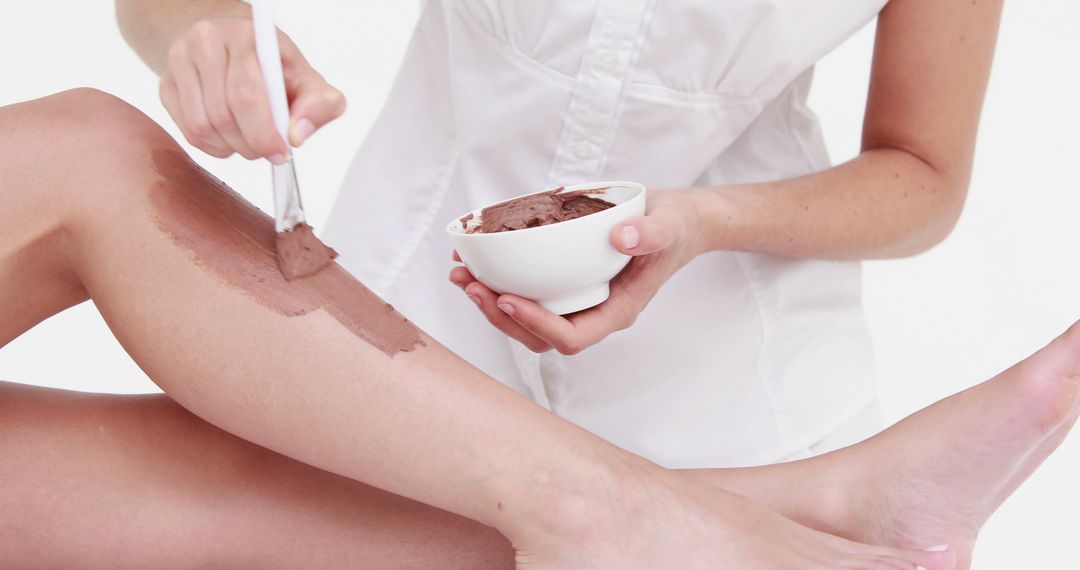 Applying Chocolate Body Wrap Treatment on Leg - Free Images, Stock Photos and Pictures on Pikwizard.com