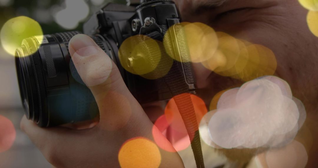 Professional Photographer Adjusting Camera with Bokeh Lights