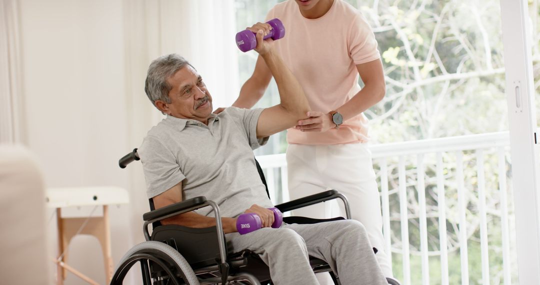 Elderly Man Exercising in Wheelchair with Caregiver at Home - Free Images, Stock Photos and Pictures on Pikwizard.com