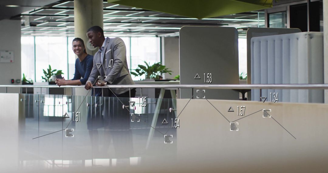 Colleagues Engaging Amidst Digital Data Graphics in Modern Office