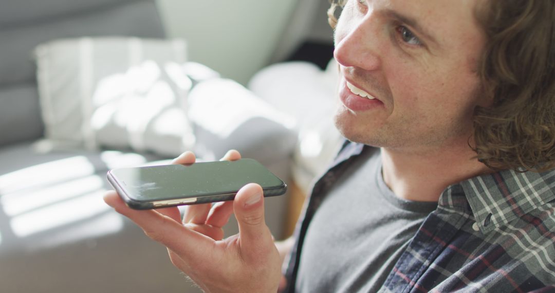 Man Using Voice Command on Smartphone at Home - Free Images, Stock Photos and Pictures on Pikwizard.com