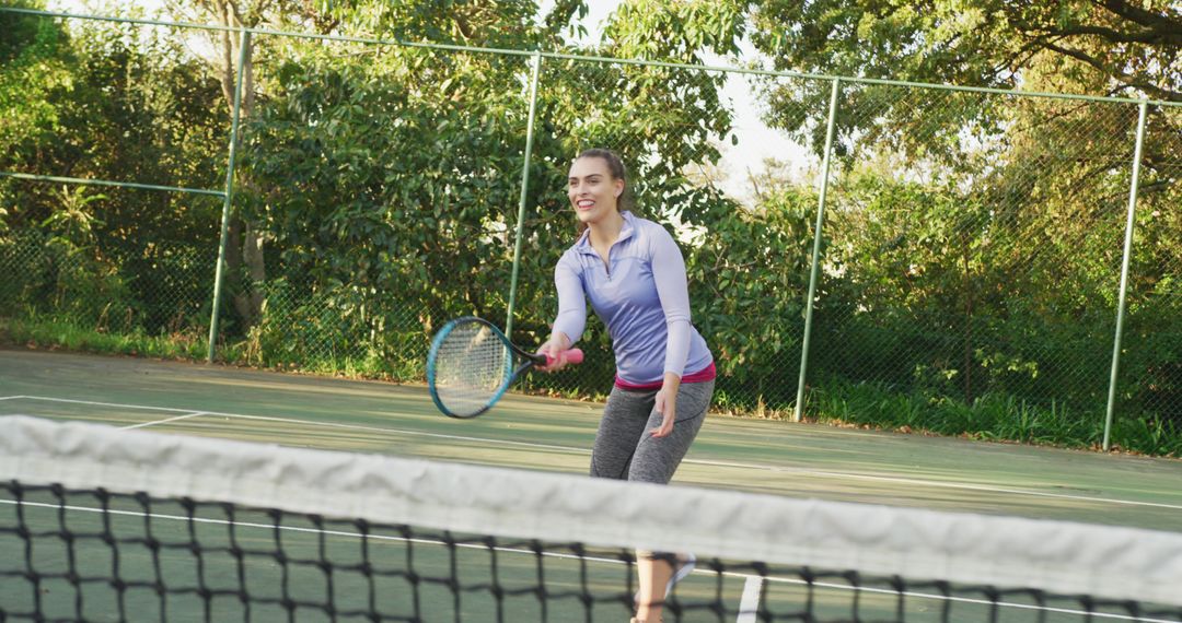 Smiling Woman Enjoying Tennis on Outdoor Court - Free Images, Stock Photos and Pictures on Pikwizard.com