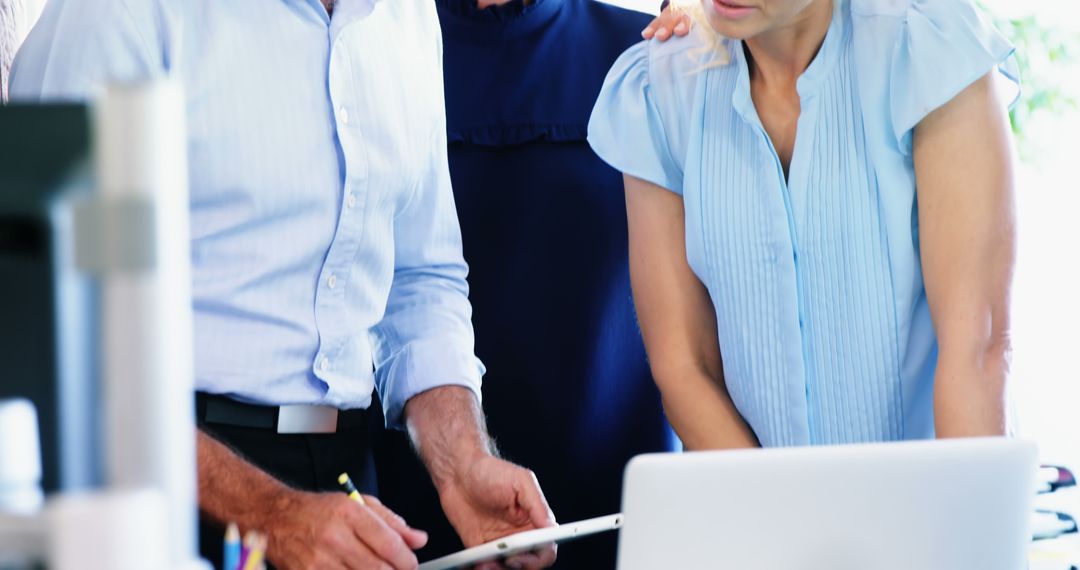 Business Team Analyzing Data on Tablet and Laptop in Office - Free Images, Stock Photos and Pictures on Pikwizard.com