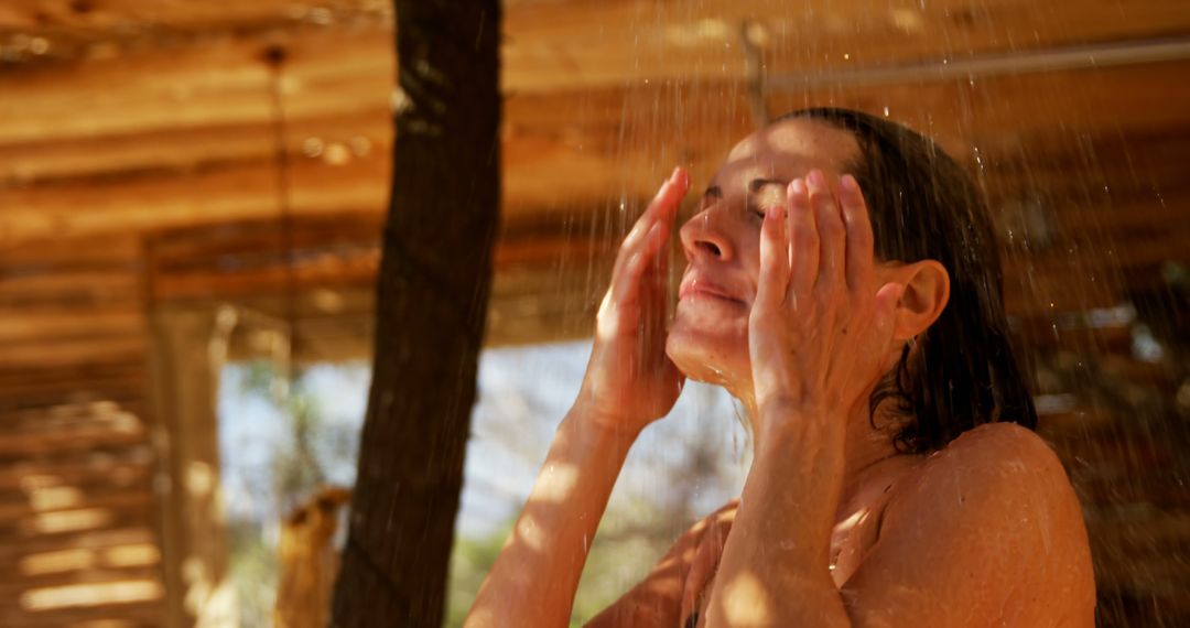 Woman Enjoying Refreshing Outdoor Shower On A Warm Day - Free Images, Stock Photos and Pictures on Pikwizard.com