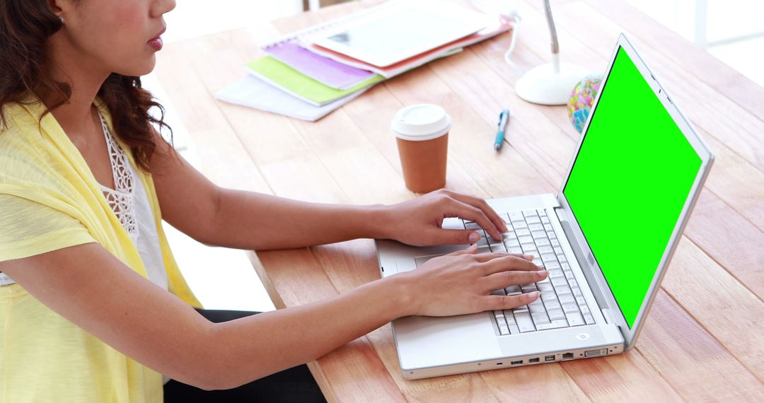 Woman Typing on Laptop with Green Screen at Desk - Free Images, Stock Photos and Pictures on Pikwizard.com