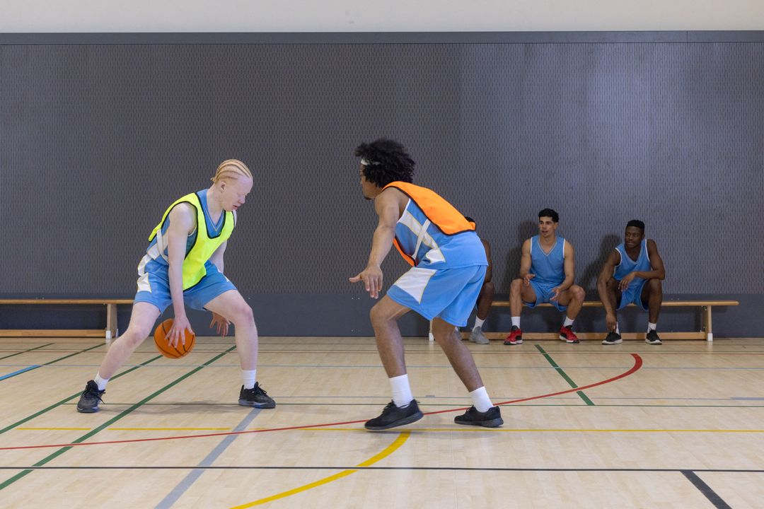 Intense Practice Basketball Scene With Focused Players in Gymnasium
